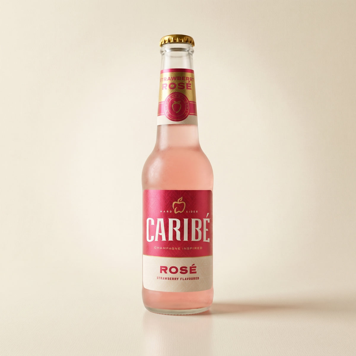 Caribé Rosé hard cider bottle on a bone studio surface