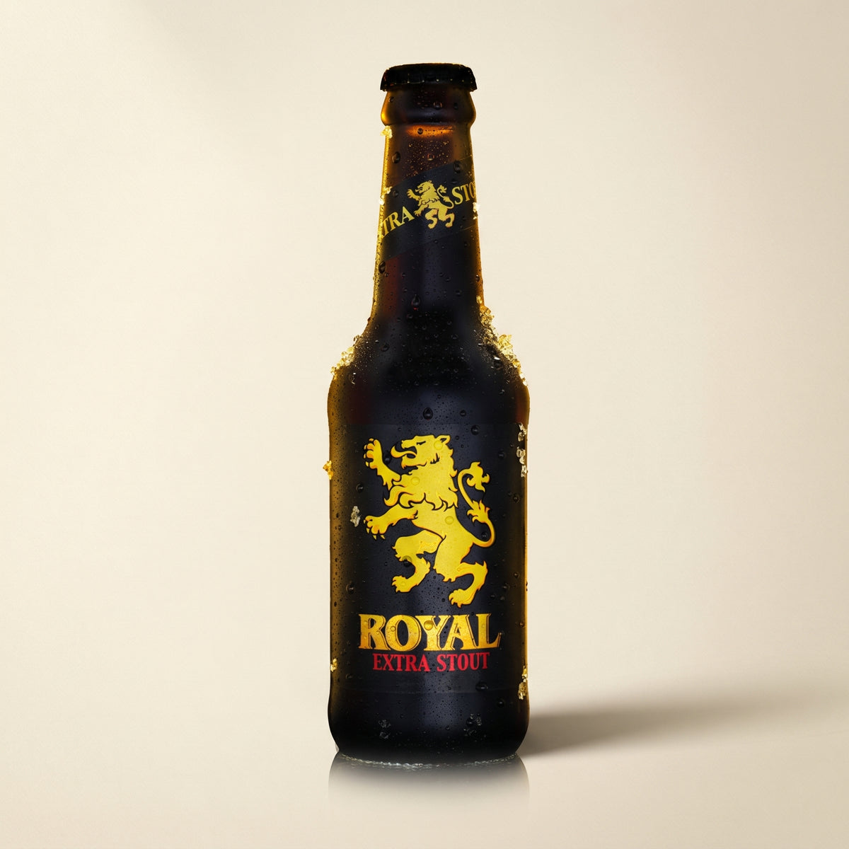 Royal Extra Stout bottle on a bone studio surface