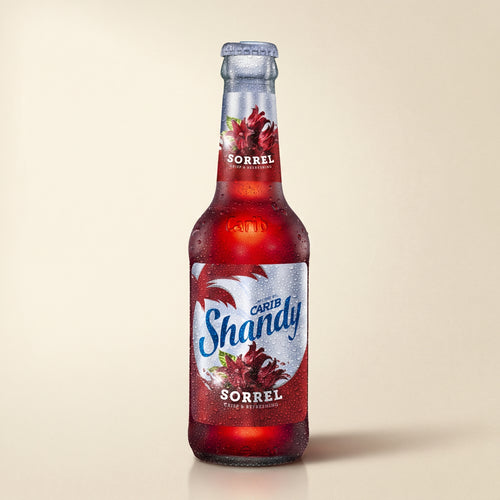 Carib Shandy Sorrel bottle on a bone studio surface