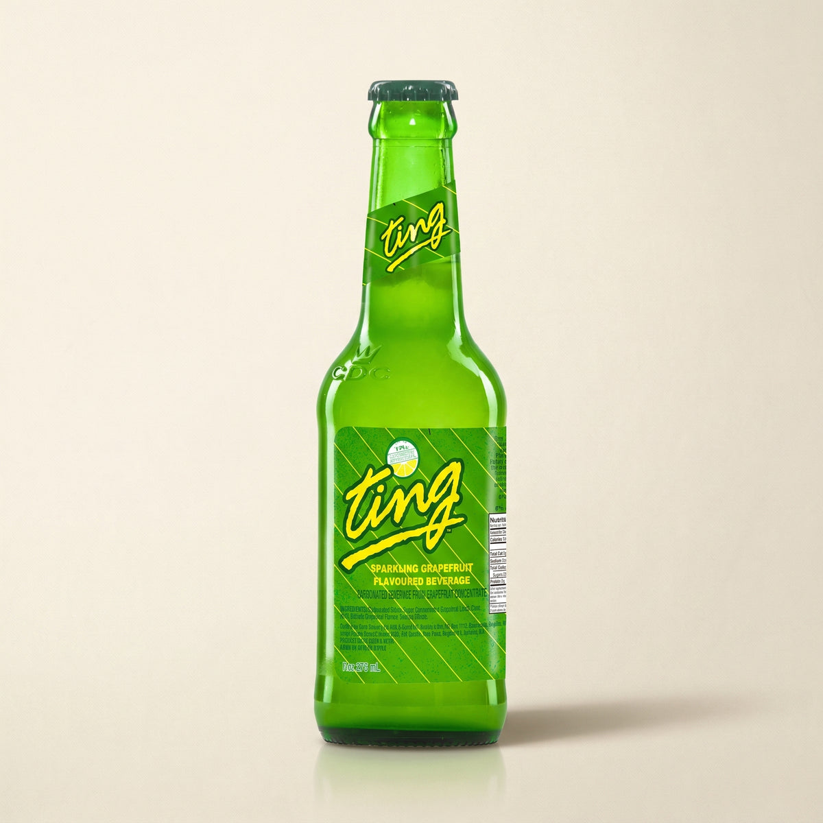 Ting grapefruit soda bottle on a bone studio surface