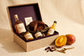 Bellyful Box: Mango Season 2026: island rum, rum cake, mango jam, mango chutney and mango pepper sauce in a linen gift box.