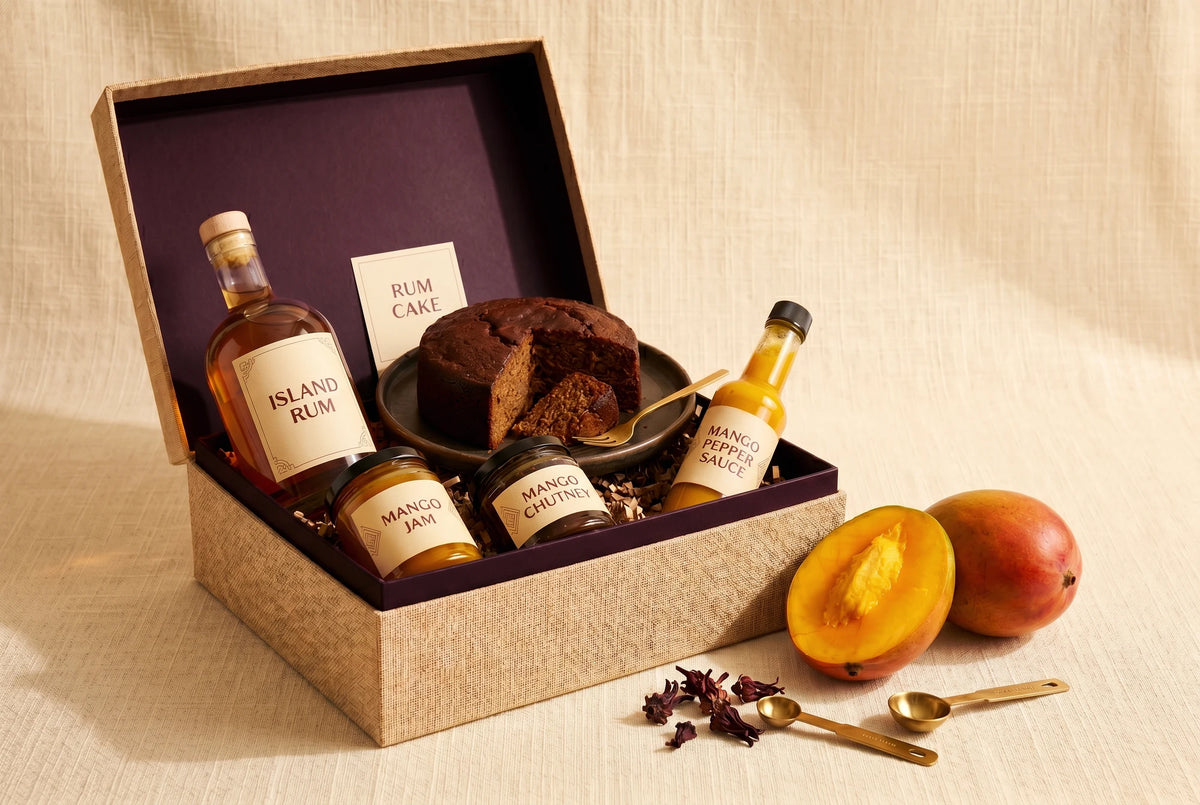 Bellyful Box: Mango Season 2026: island rum, rum cake, mango jam, mango chutney and mango pepper sauce in a linen gift box.