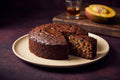 Bellyful Mango Rum Cake: a dark, dense rum-soaked cake with a slice cut to show the crumb.