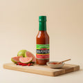 Llewellyn's Mango Pepper Sauce with whole Nevisian mango, mango slices, yellow scotch bonnet, garlic and ginger.